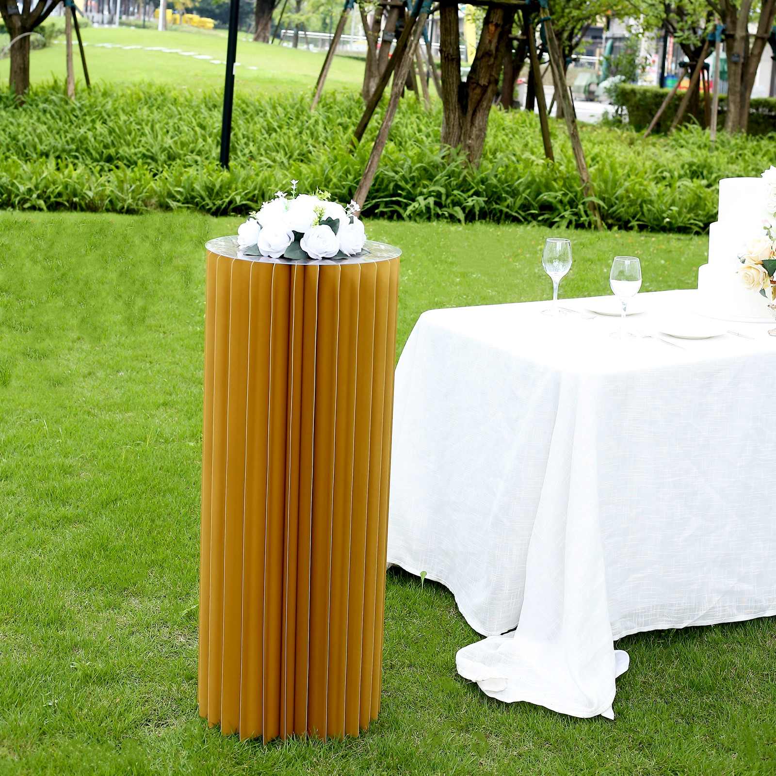 Gold cylinder display column stand with top plate, perfect for events or decor.