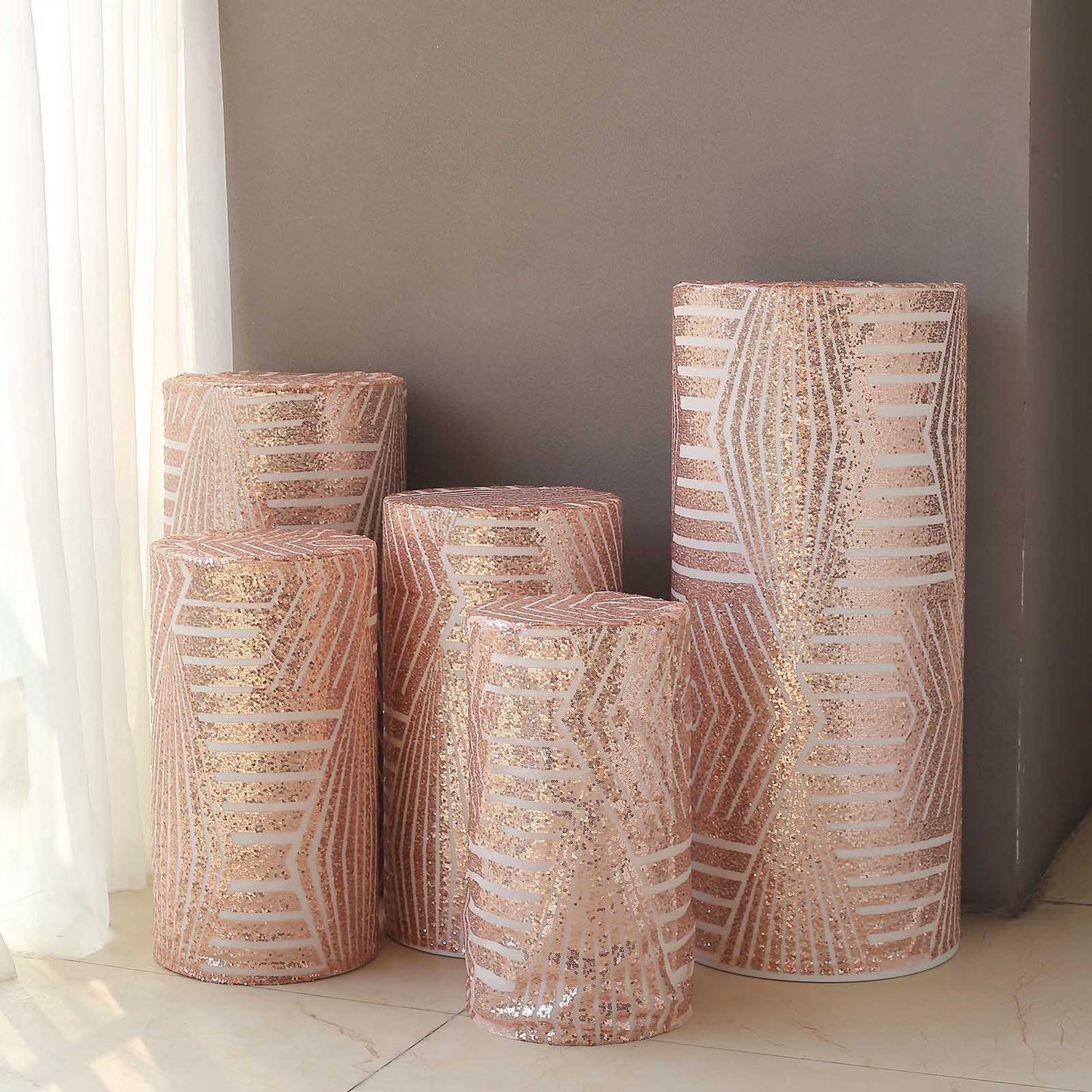 Rose gold sequin pedestal stand covers with geometric embroidery pattern.