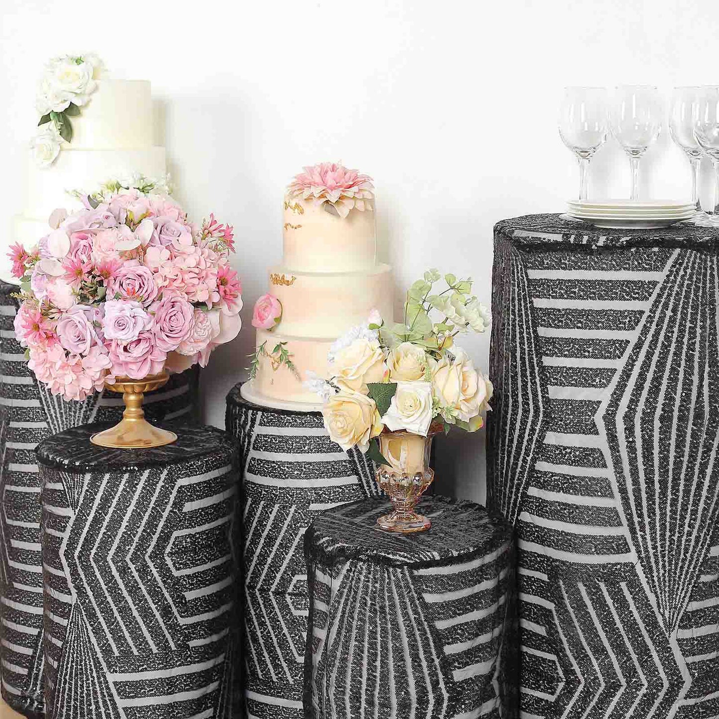 Black sequin mesh pedestal stand covers with geometric embroidery.