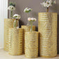 Gold sequin cylinder pedestal stand covers with geometric pattern embroidery.