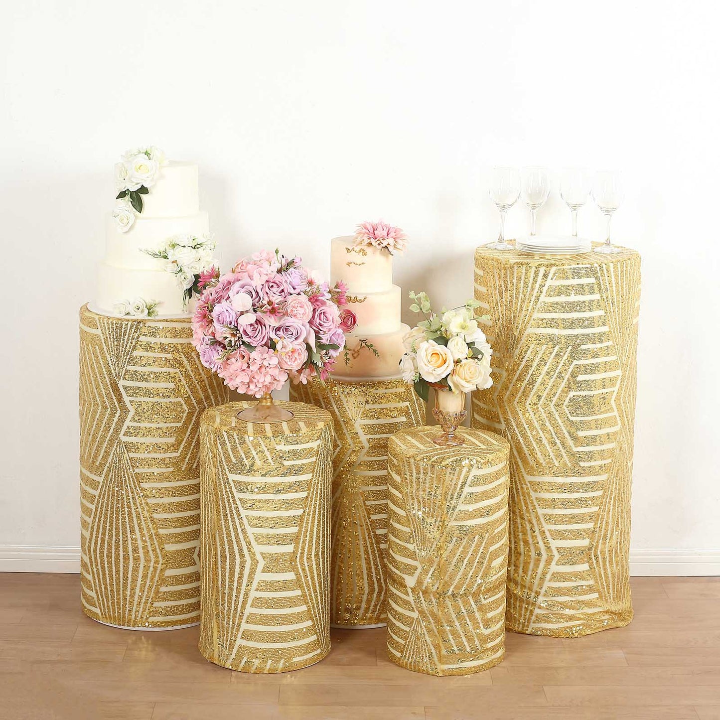 Gold sequin mesh pedestal stand covers with geometric pattern embroidery.