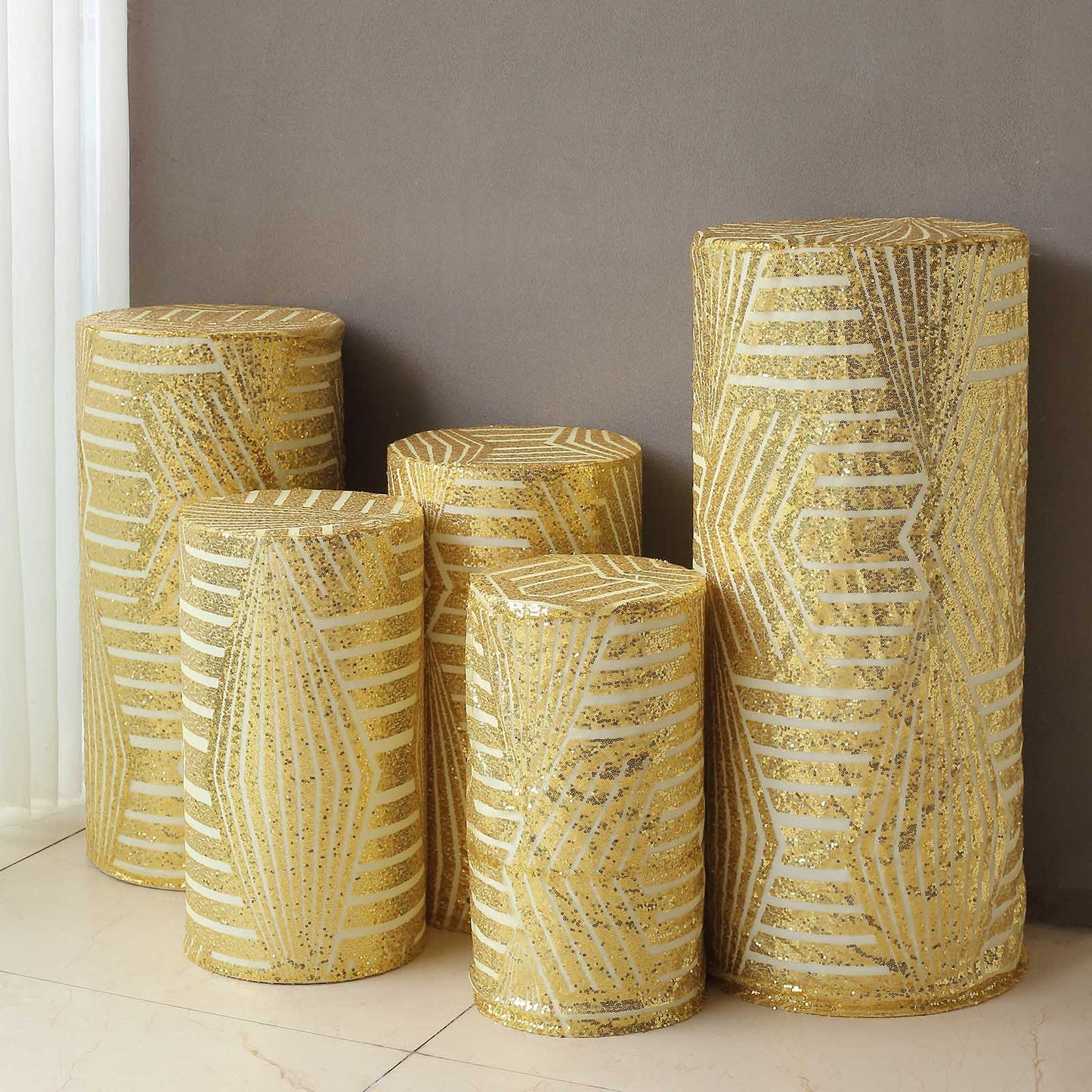 Gold sequin mesh pedestal stand covers with geometric pattern.