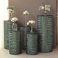 Emerald green sequin mesh pedestal stand covers with geometric embroidery.