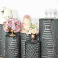 Emerald green sequin pedestal stand covers with geometric pattern embroidery.