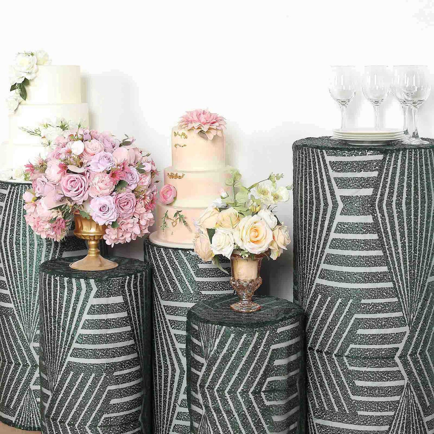 Emerald green sequin pedestal stand covers with geometric pattern embroidery.