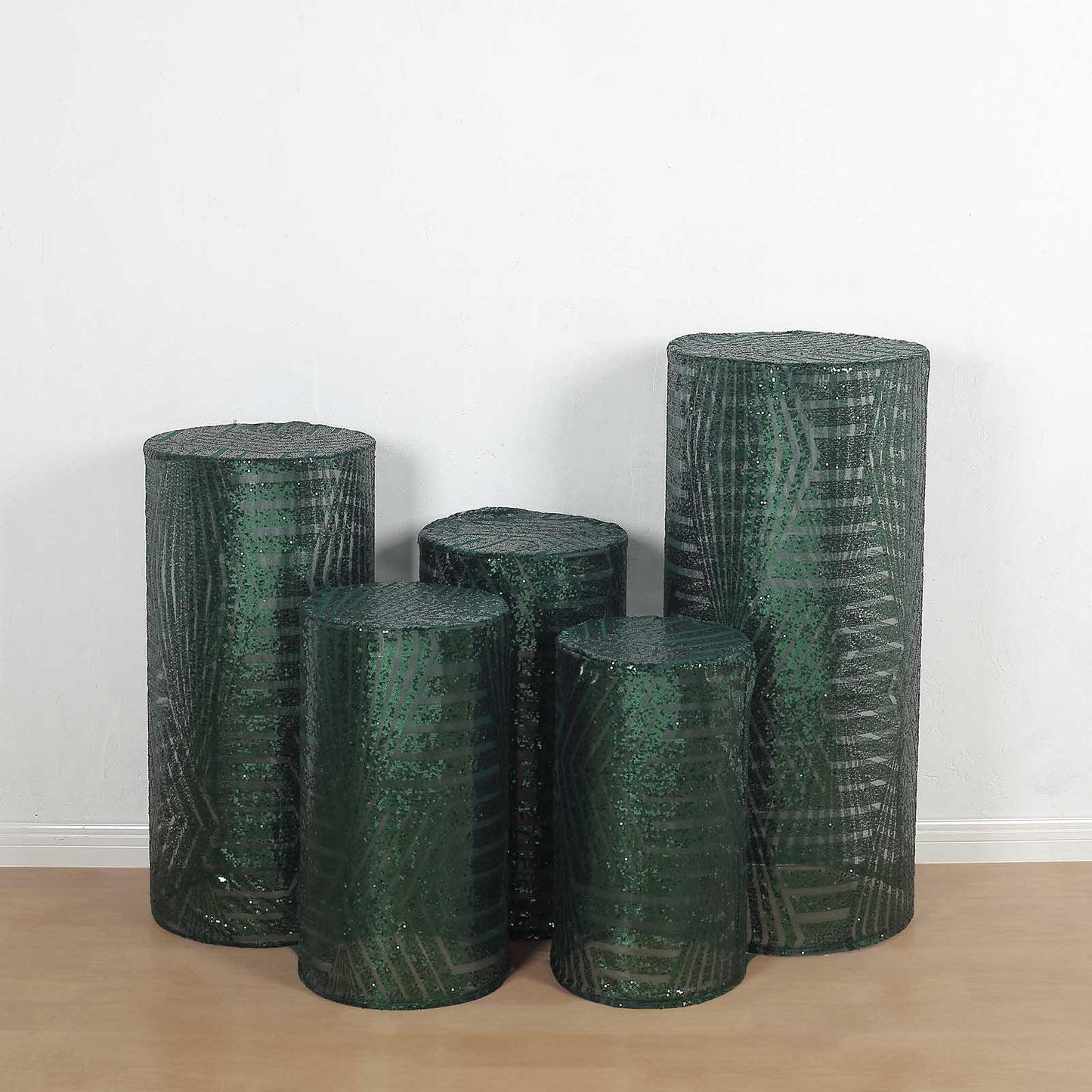 Emerald green sequin mesh pedestal stand covers with geometric embroidery.