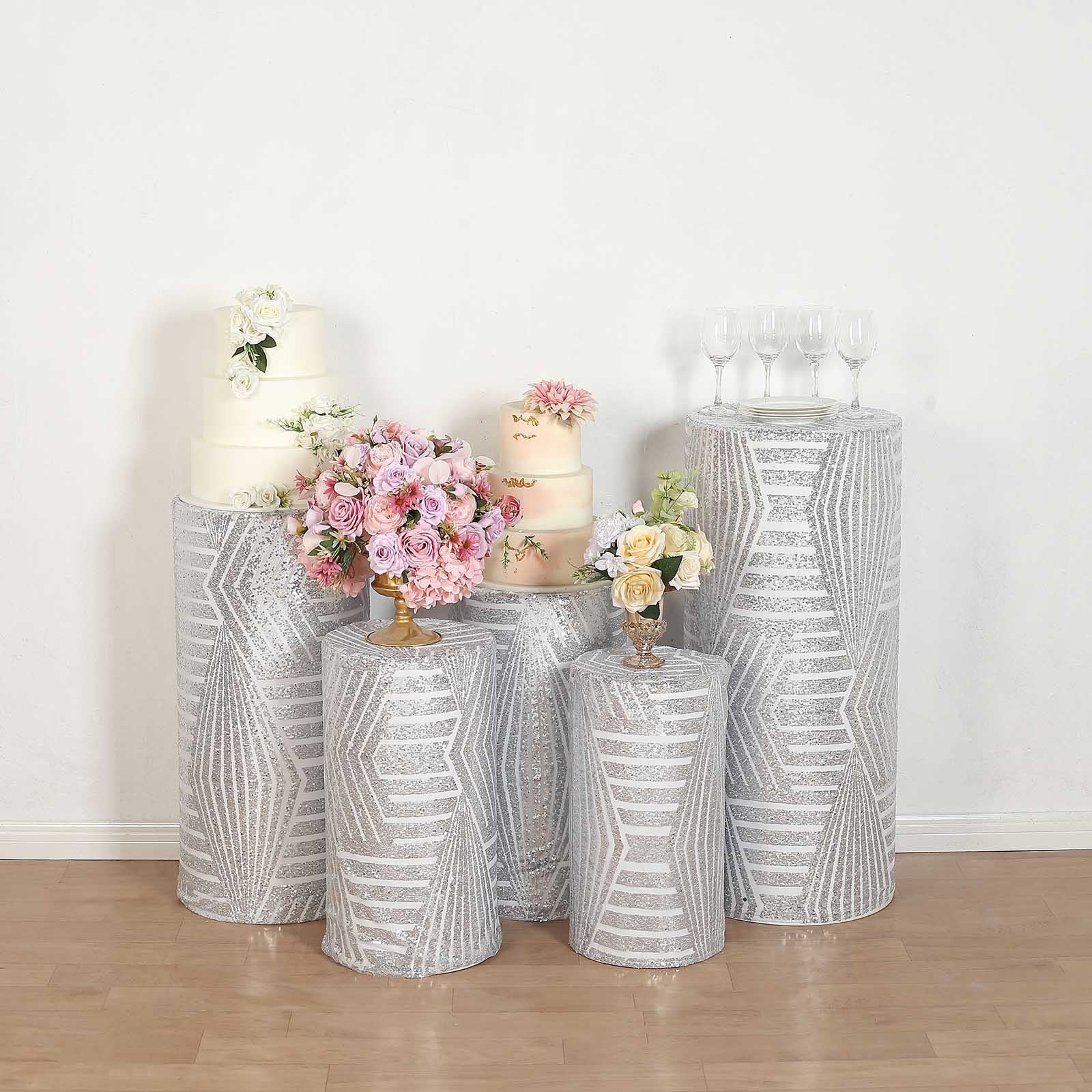 Silver sequin mesh cylinder pedestal stand covers with geometric pattern.