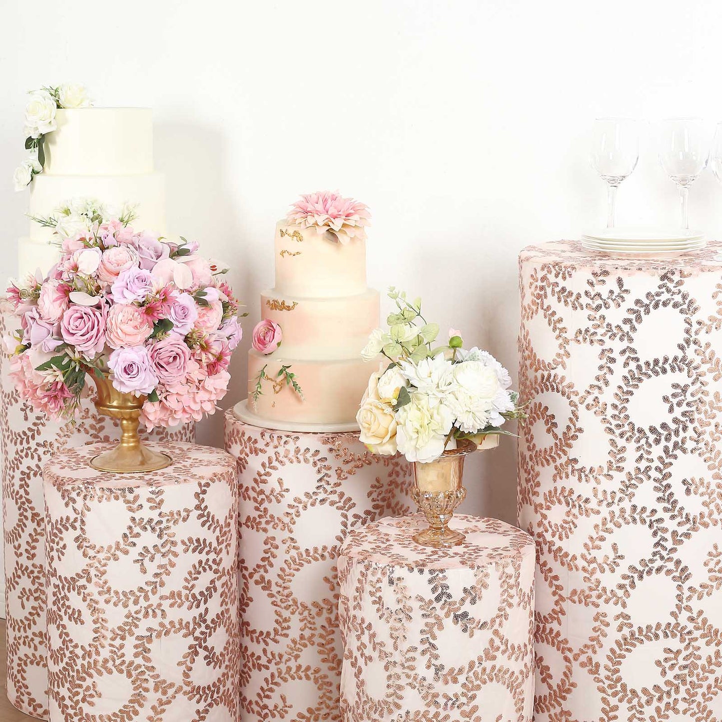 Rose gold sequin pedestal stand covers with leaf vine embroidery.