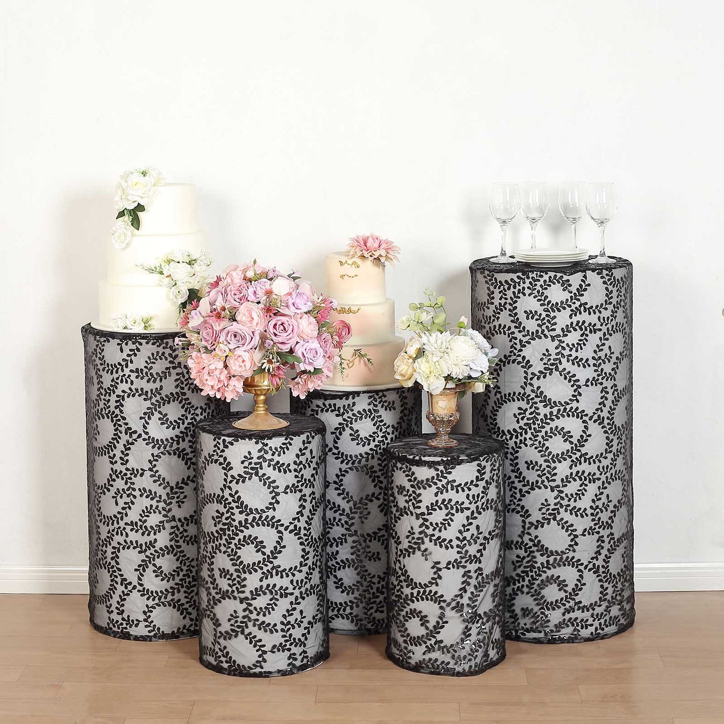 Black sequin mesh pedestal stand covers with leaf vine embroidery.