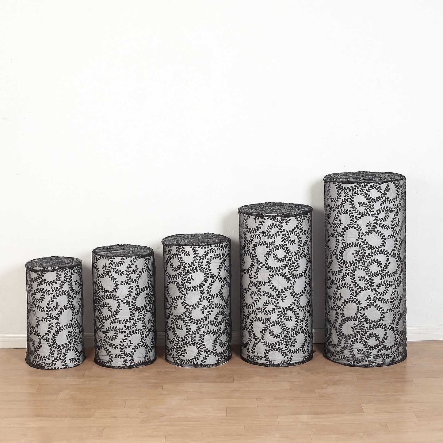Black sequin mesh cylinder pedestal stand covers with leaf vine embroidery.