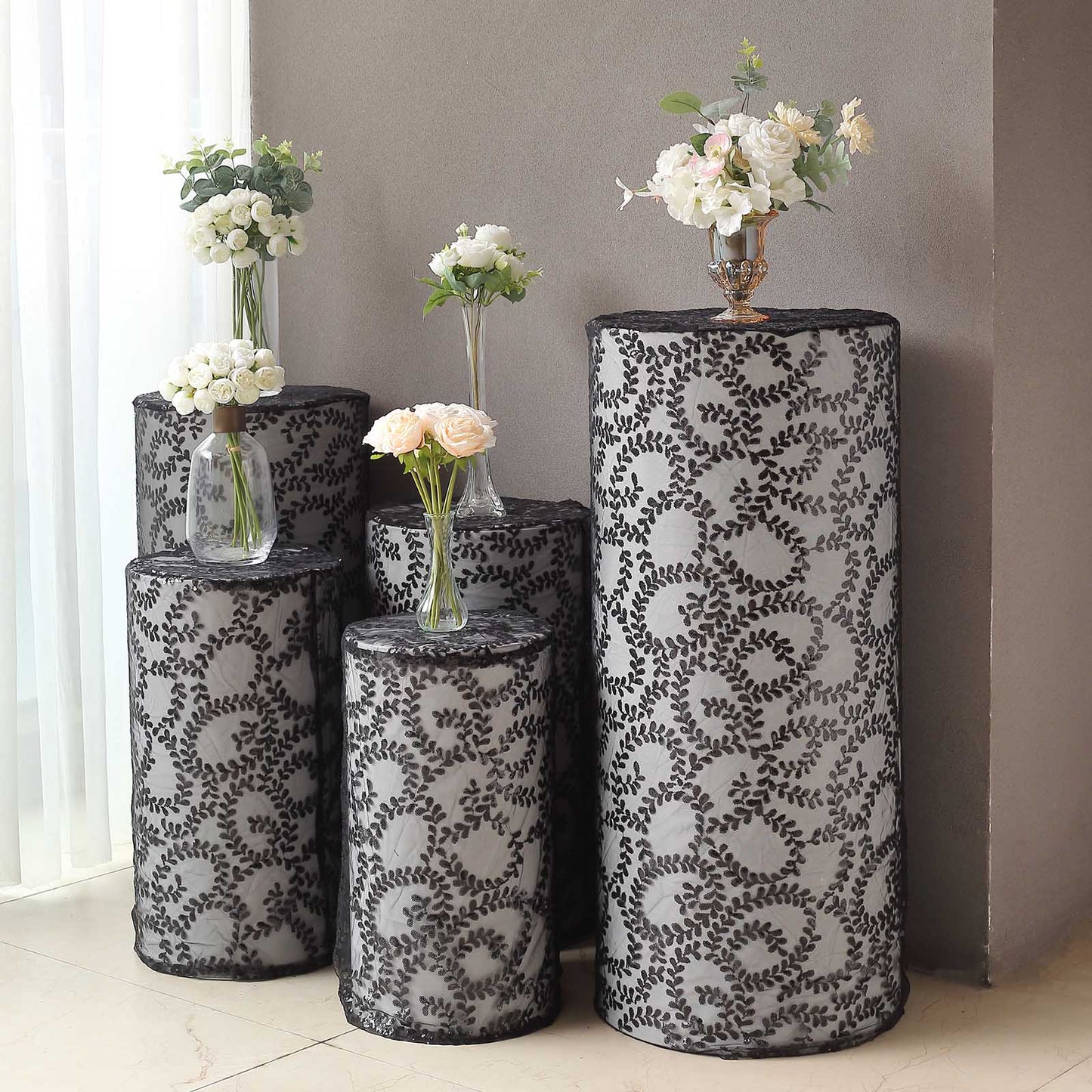 Black sequin mesh pedestal stand covers with leaf vine embroidery.