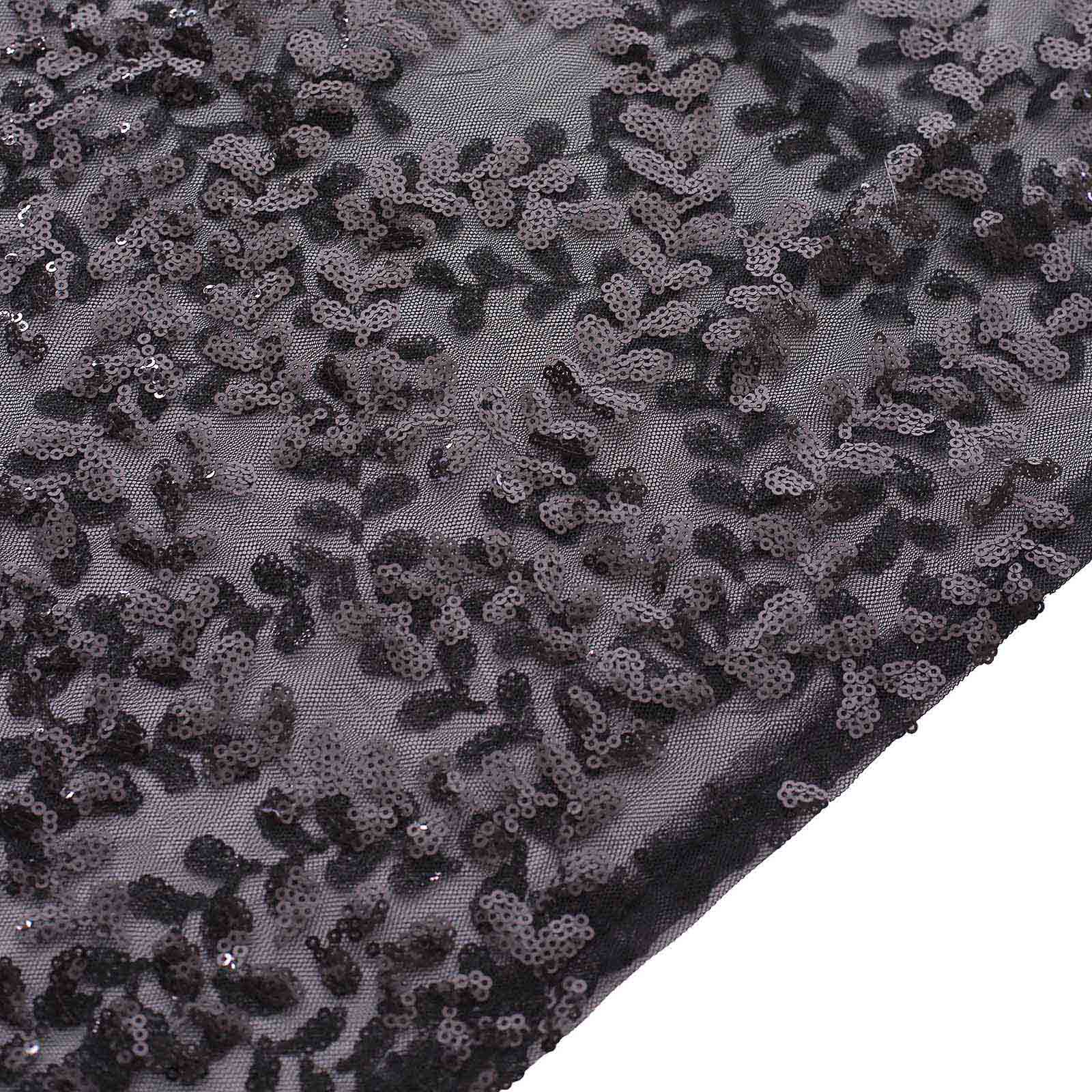 Black sequin mesh fabric with leaf vine embroidery detail.