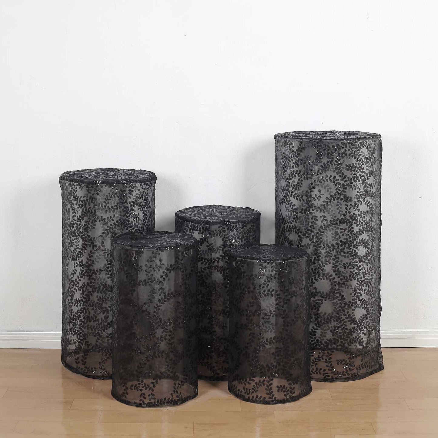 Black sequin mesh pedestal stand covers with leaf vine embroidery.