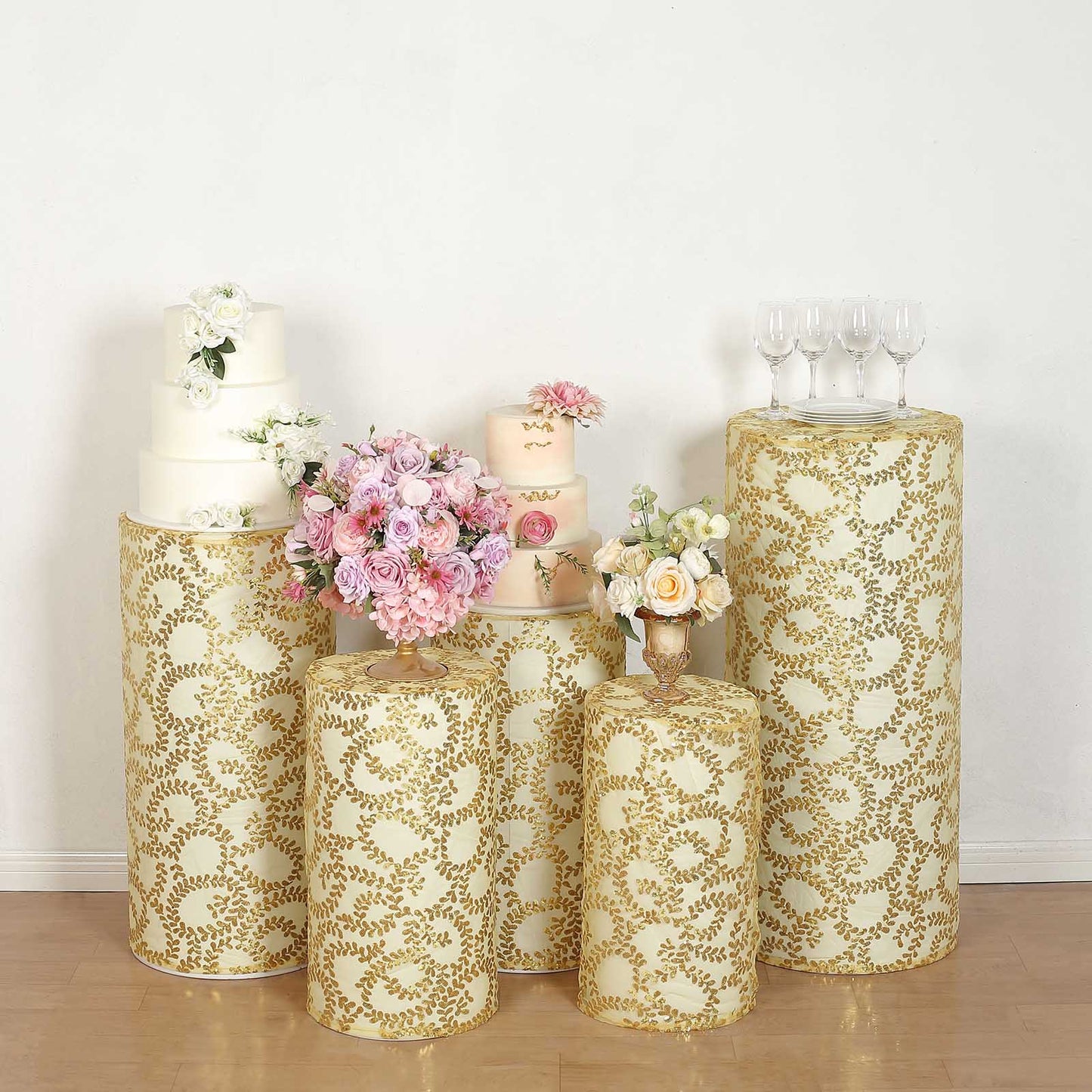 Gold sequin mesh pedestal stand covers with leaf vine embroidery.
