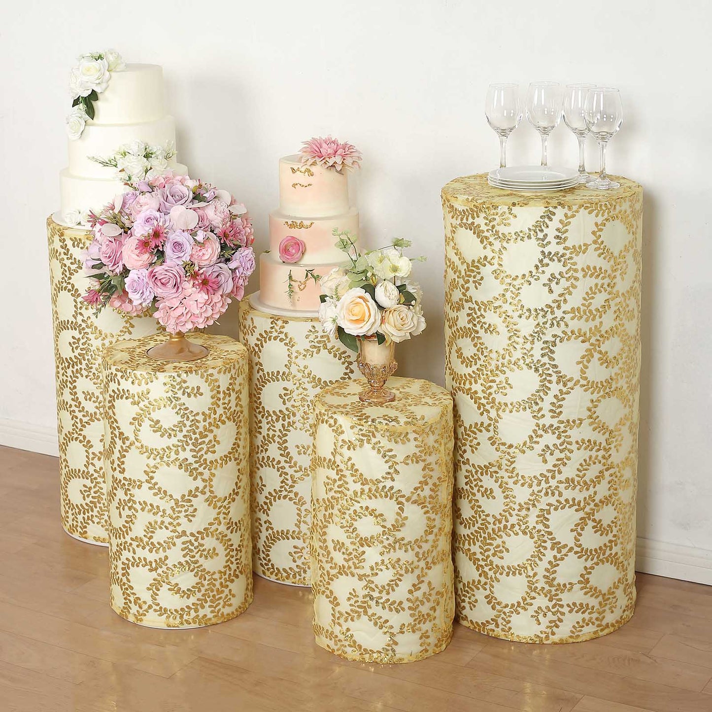 Gold sequin mesh pedestal stand covers with leaf vine embroidery.