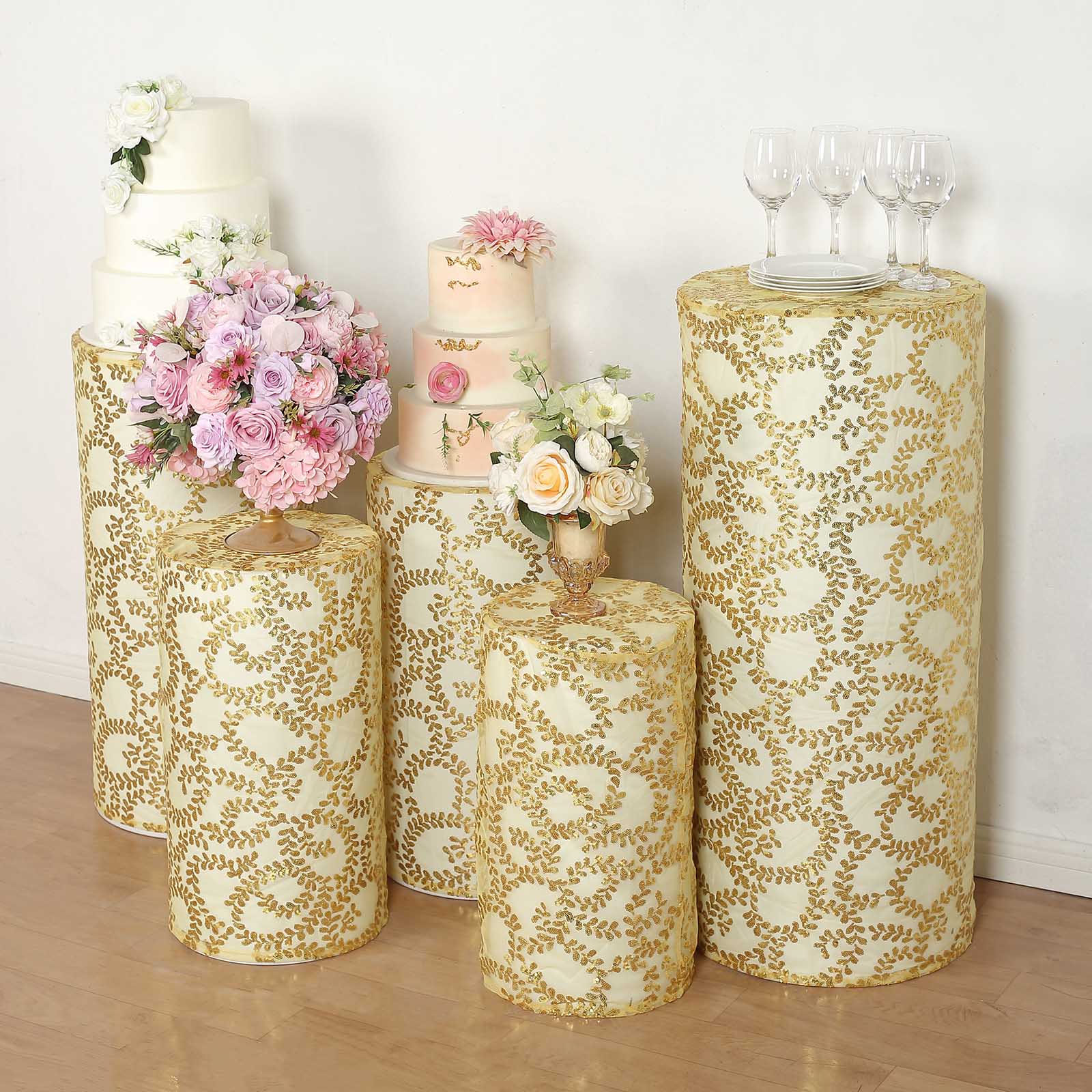 Gold sequin mesh pedestal stand covers with leaf vine embroidery.