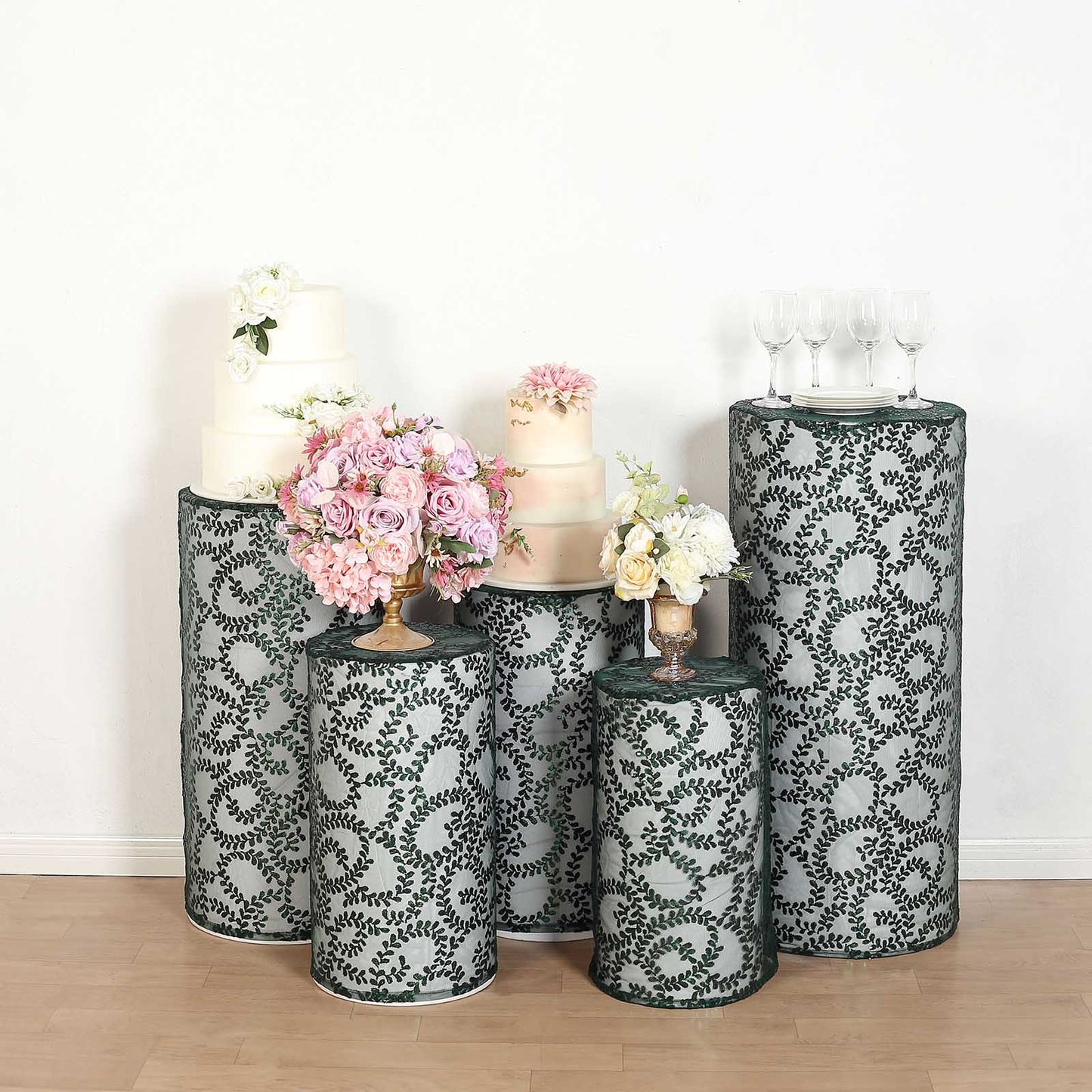 Emerald green sequin mesh pedestal stand covers with leaf vine embroidery.