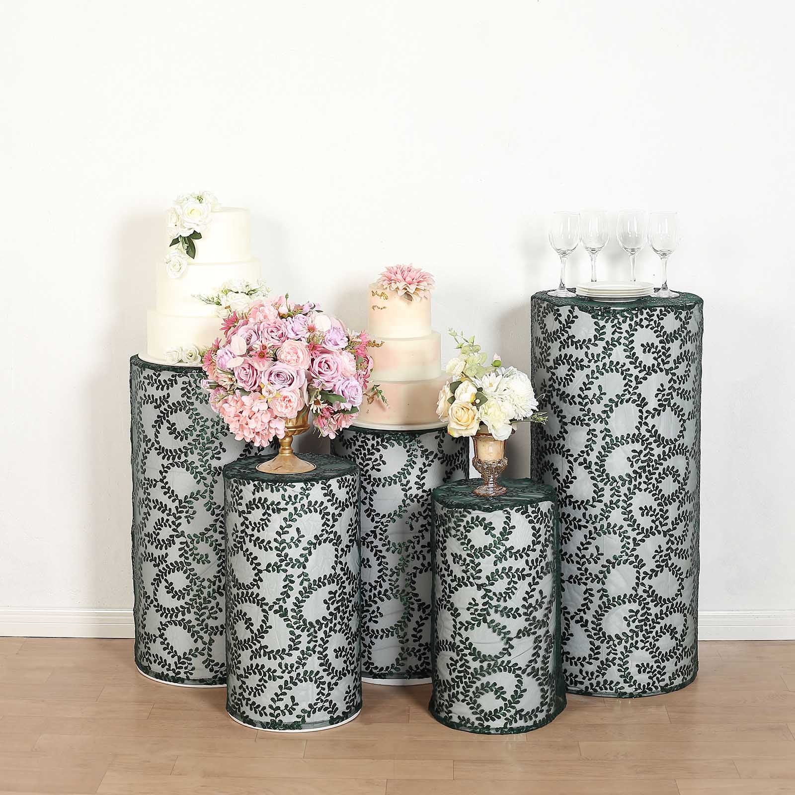 Emerald green sequin mesh pedestal stand covers with leaf vine embroidery.