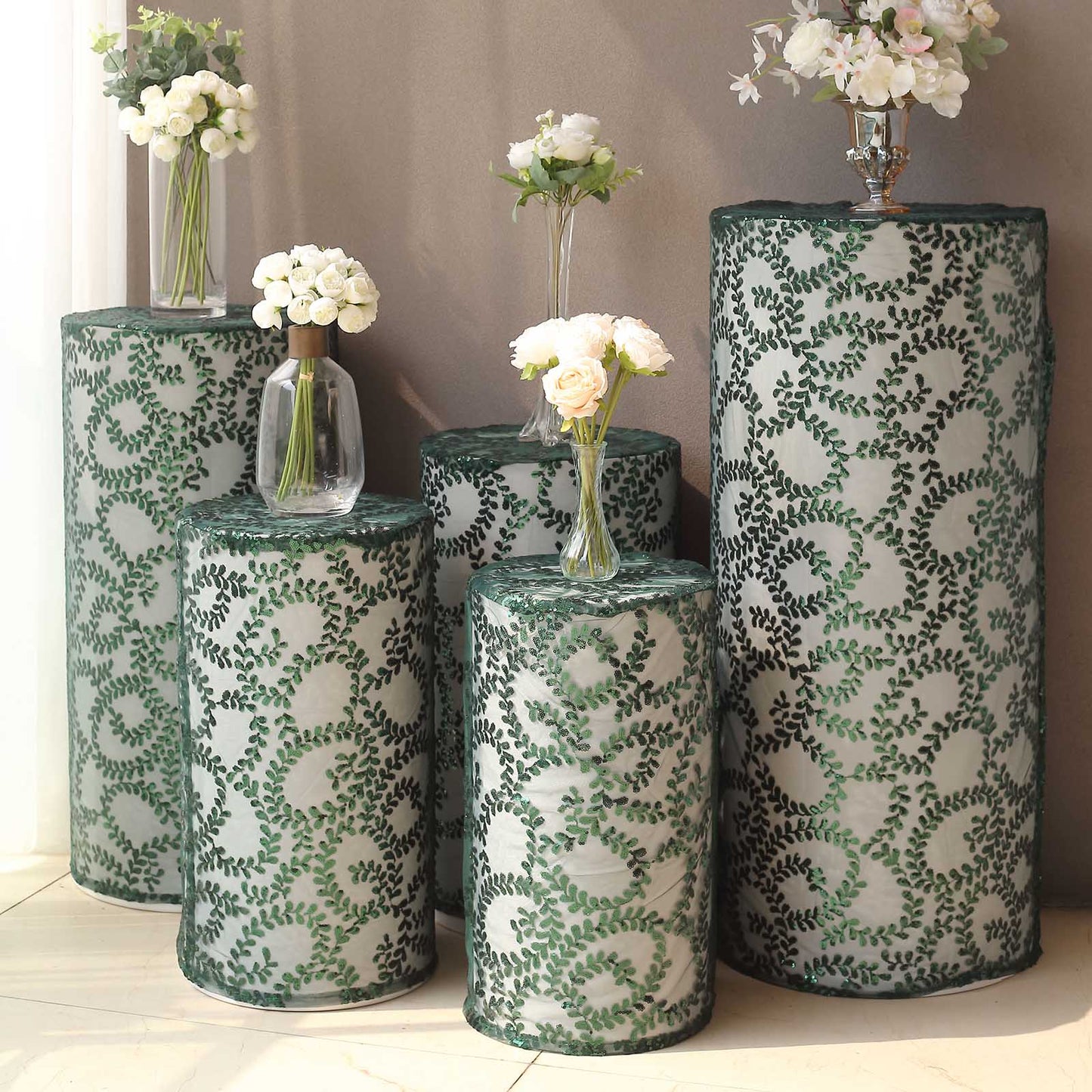 Emerald green sequin mesh pedestal stand covers with leaf vine embroidery.