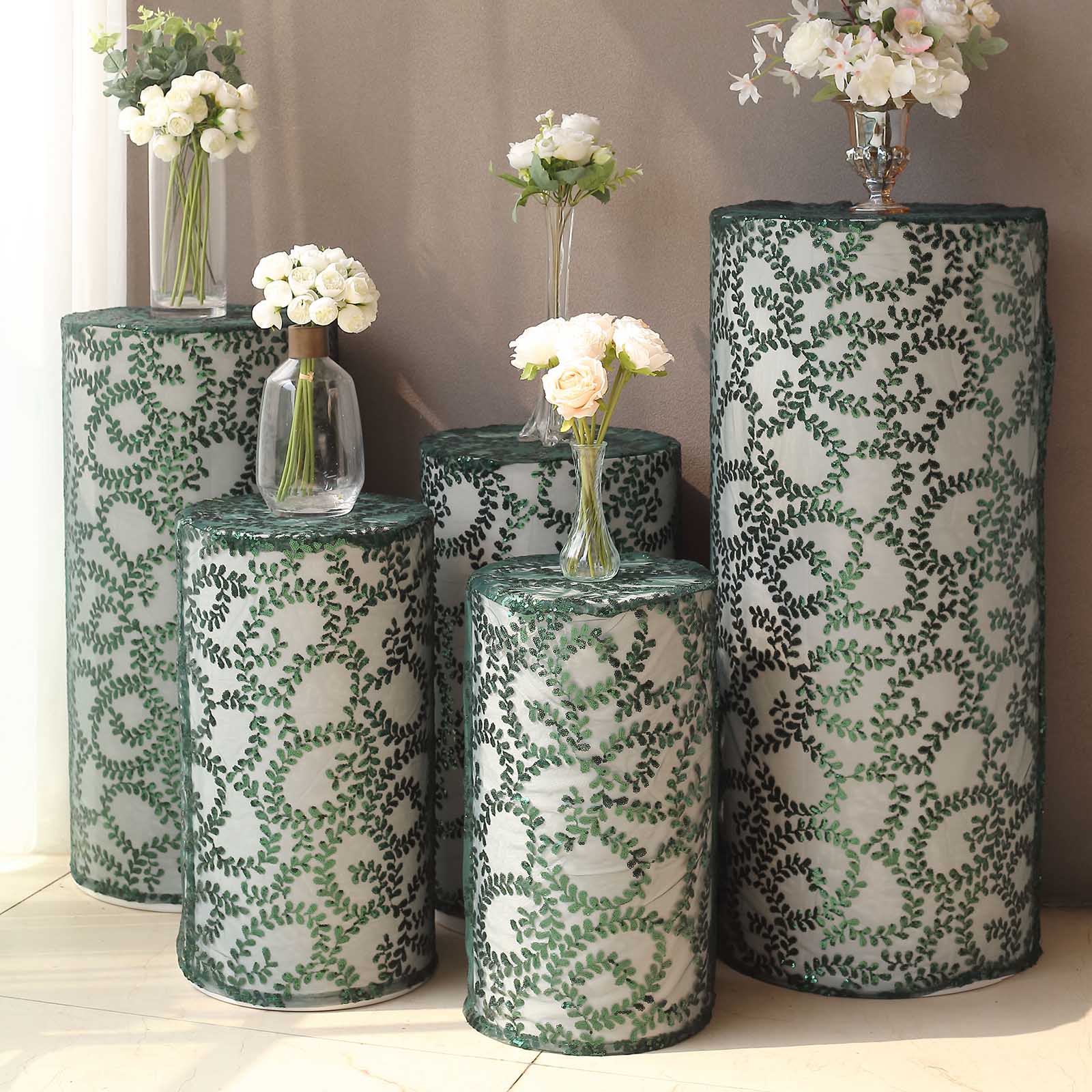 Emerald green sequin mesh pedestal stand covers with leaf vine embroidery.