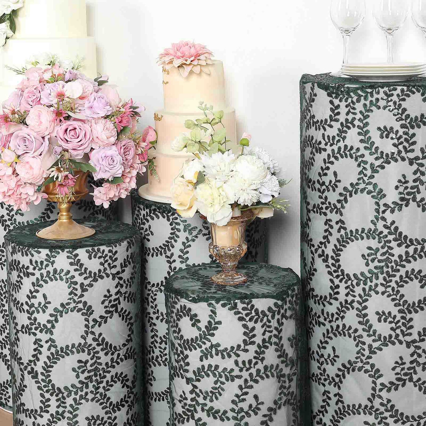 Emerald green sequin mesh pedestal stand covers with leaf vine embroidery.