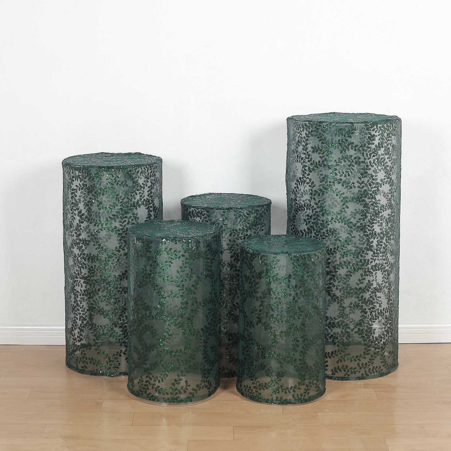 Emerald green sequin mesh pedestal stand covers with leaf vine embroidery.