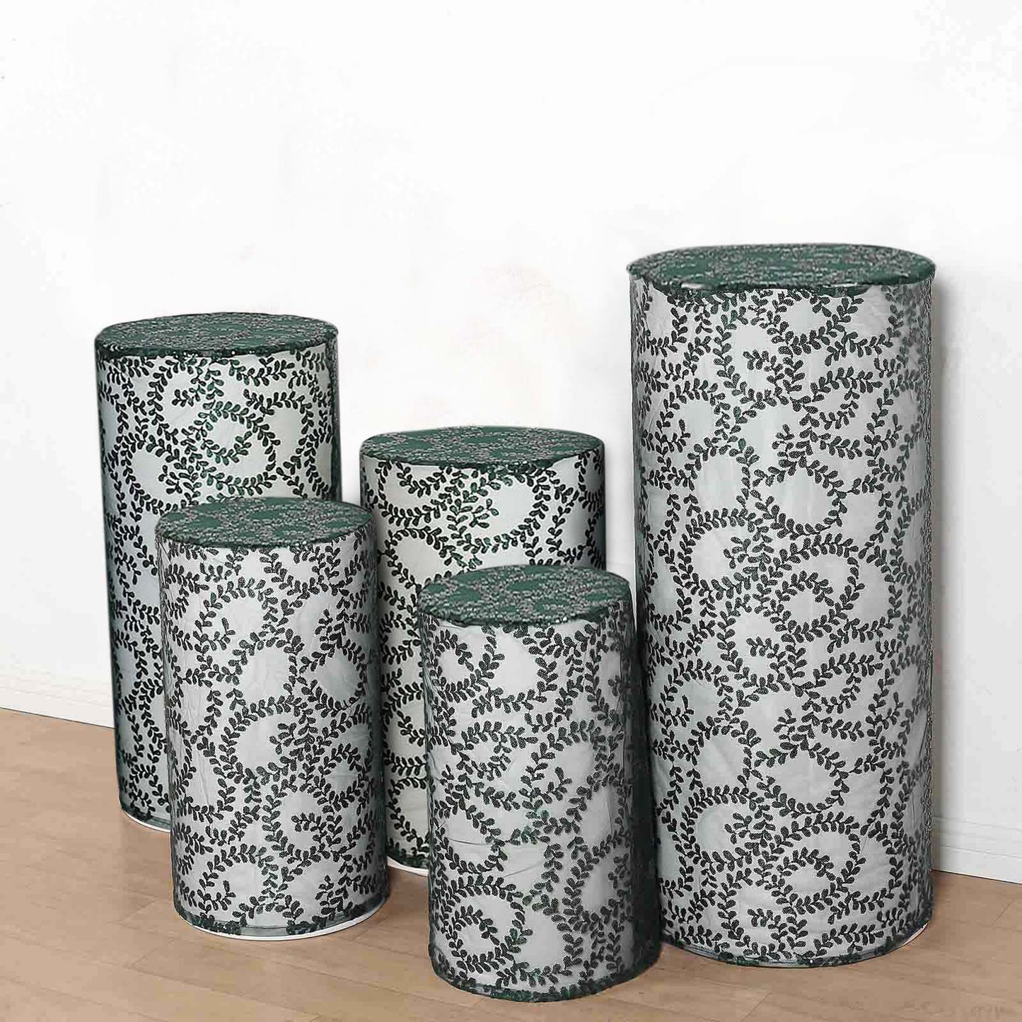 Emerald green sequin mesh pedestal stand covers with leaf vine embroidery.