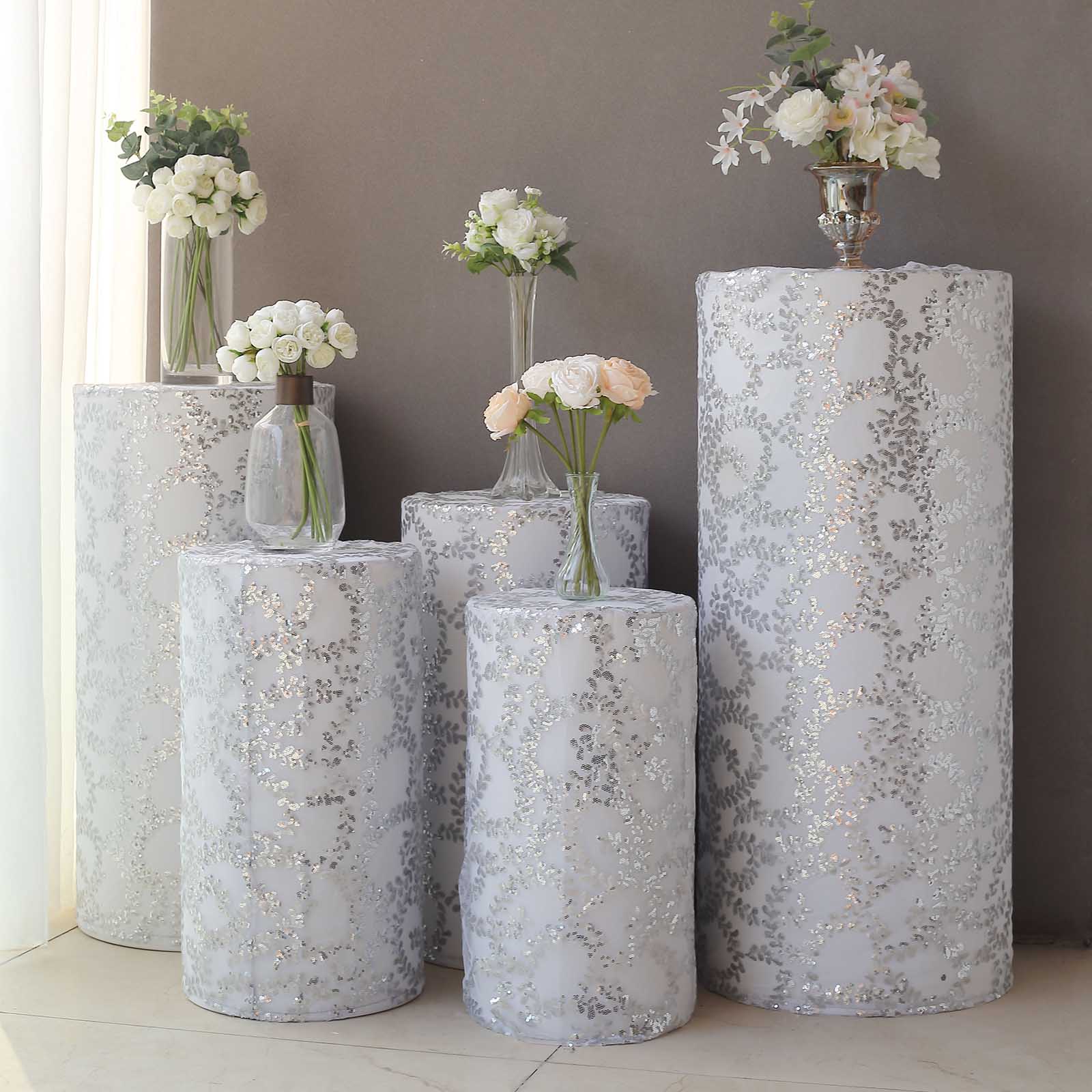 Silver sequin mesh pedestal stand covers with leaf vine embroidery.