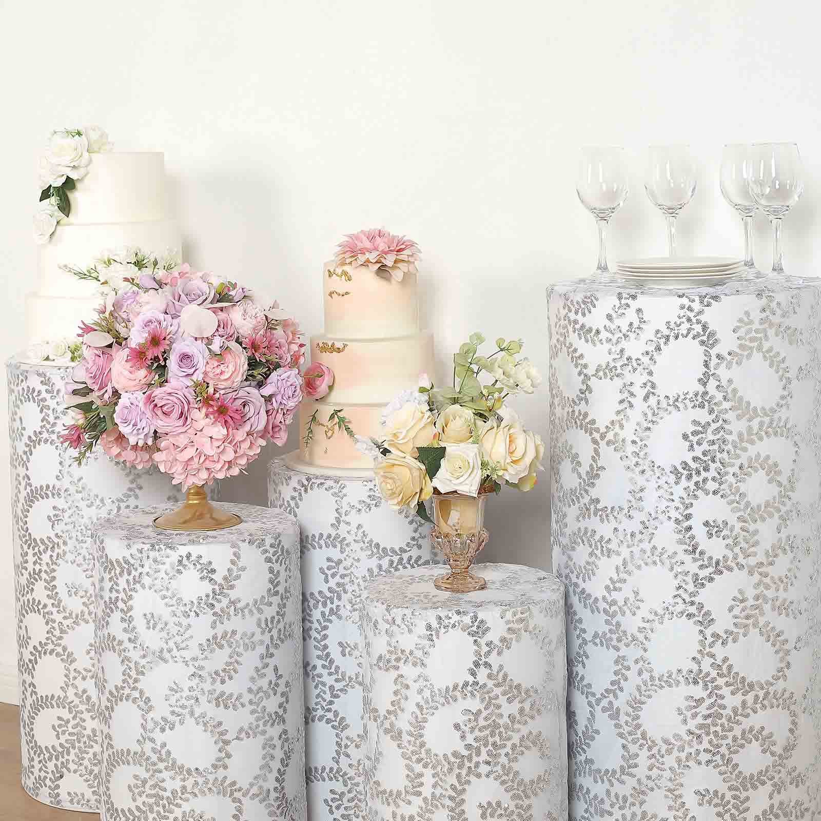 Silver sequin mesh pedestal stand covers with leaf vine embroidery.
