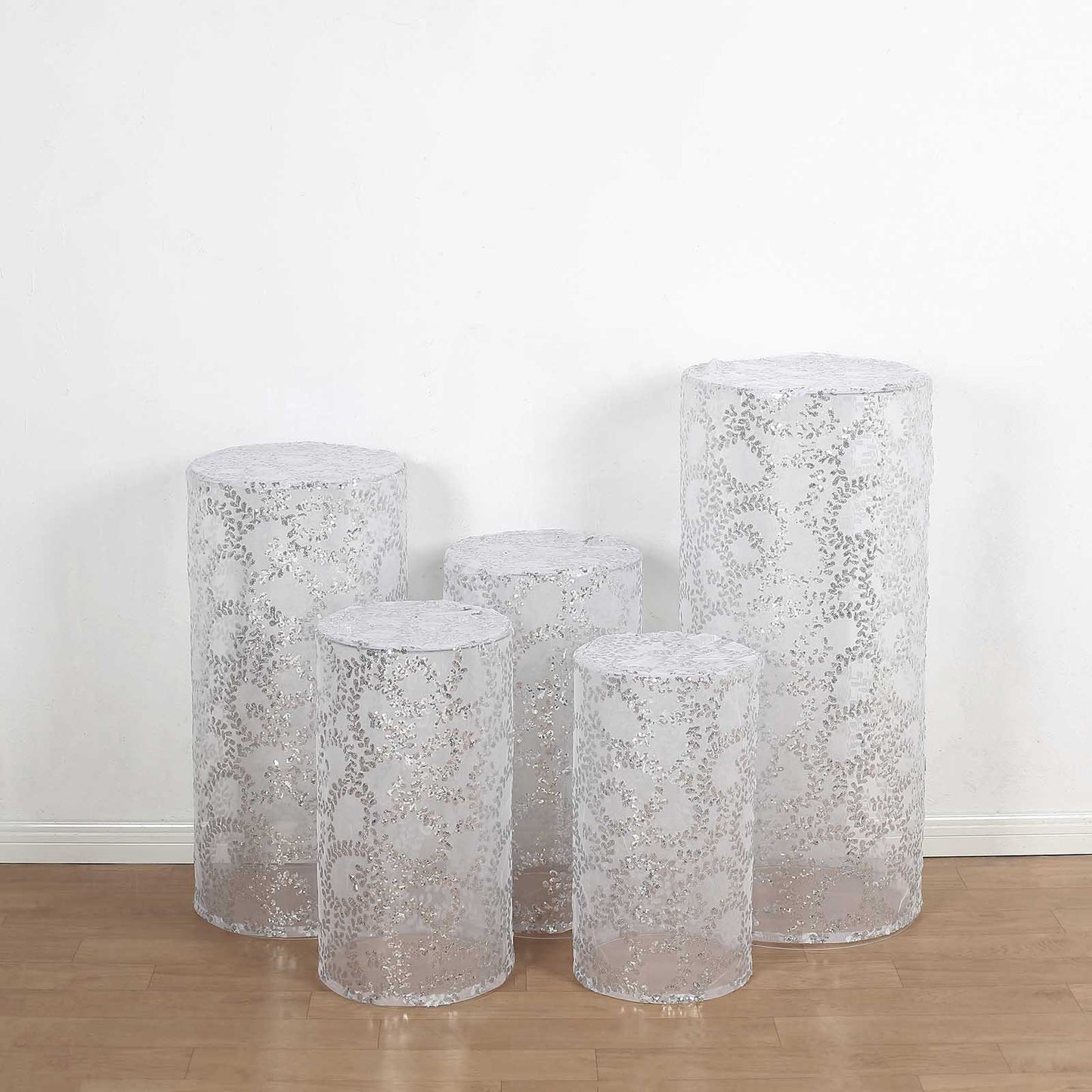 Set of 5 silver sequin mesh pedestal stand covers with leaf vine embroidery.