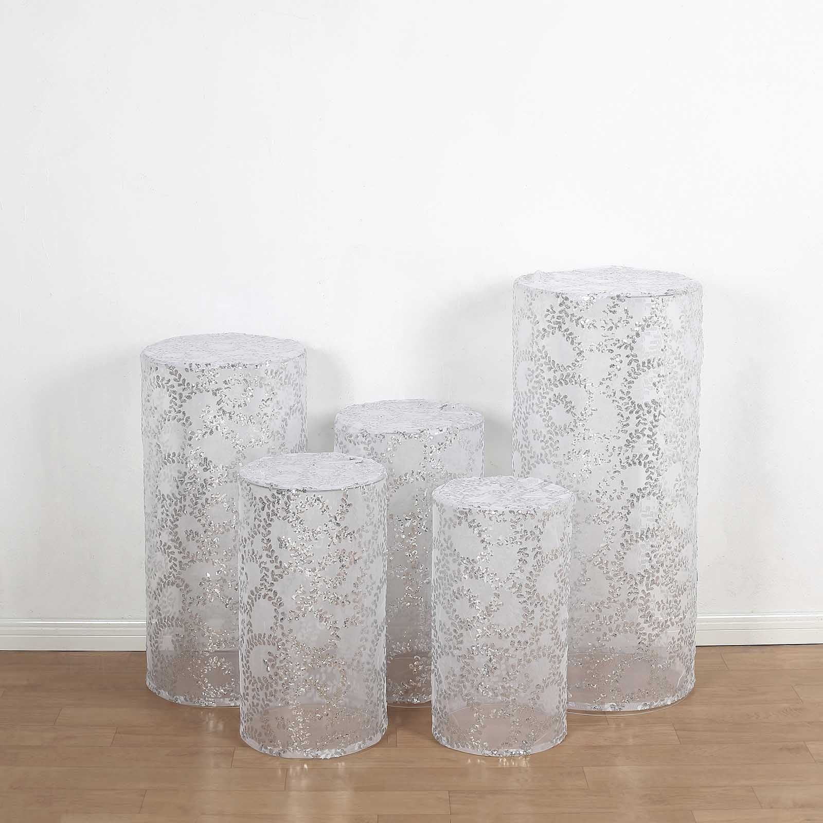 Set of 5 silver sequin mesh pedestal stand covers with leaf vine embroidery.
