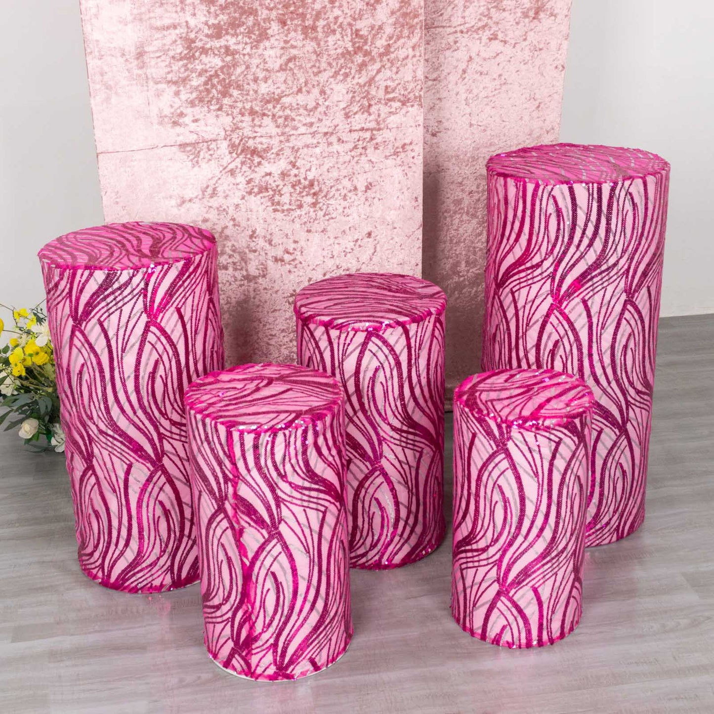 Fuchsia wave mesh cylinder pedestal stand covers with sequins.