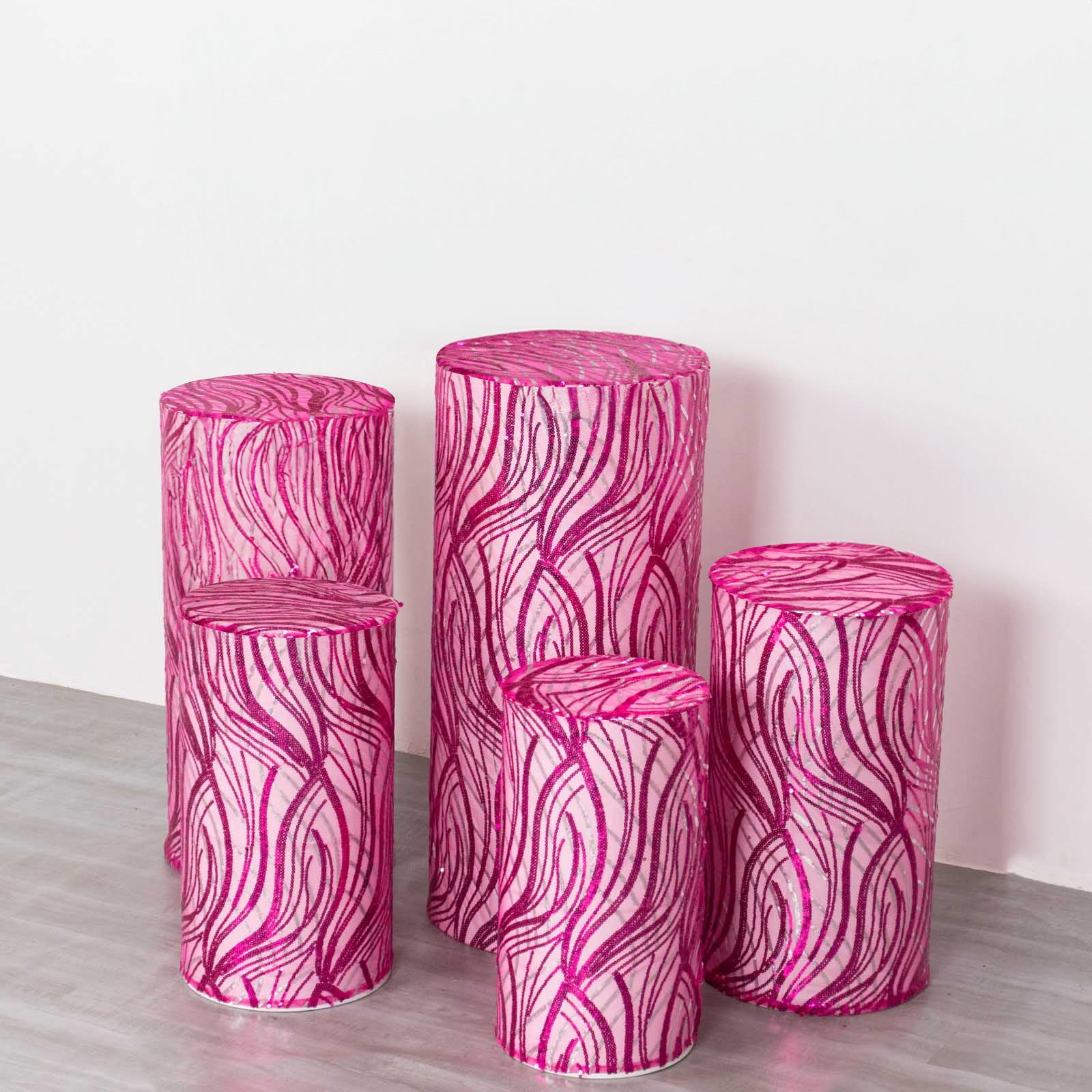 Fuchsia wave mesh cylinder pedestal stand covers with sequins.