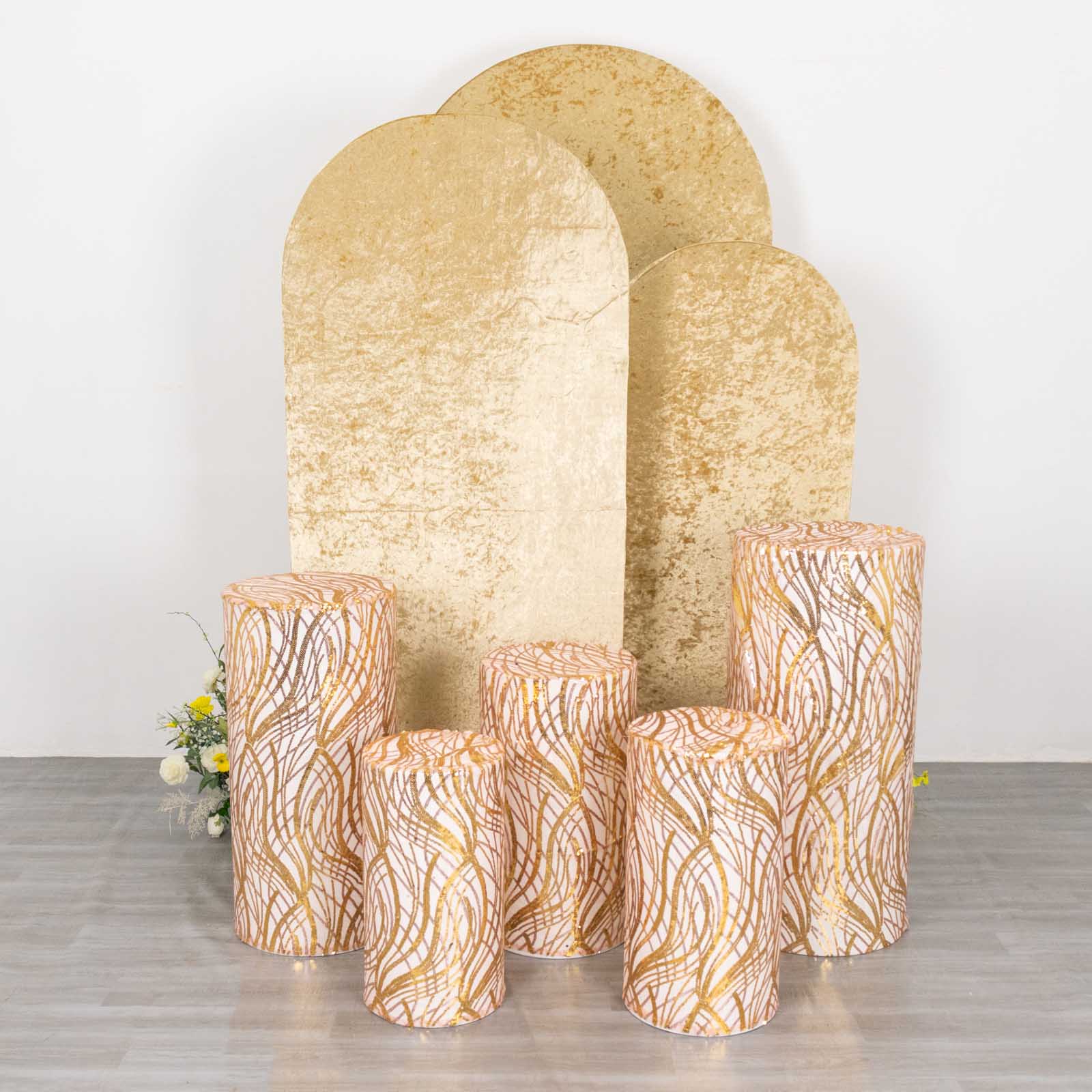 Set of 5 rose gold wave mesh cylinder pedestal stand covers with sequins.