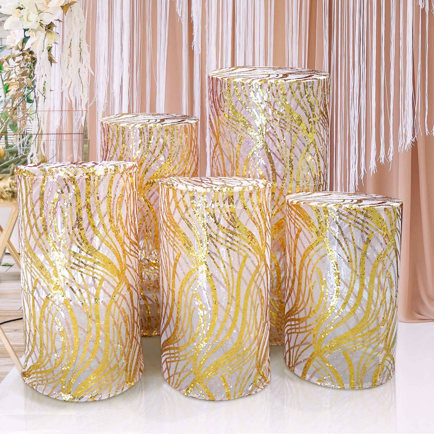 Set of 5 rose gold wave mesh cylinder pedestal stand covers with sequins.