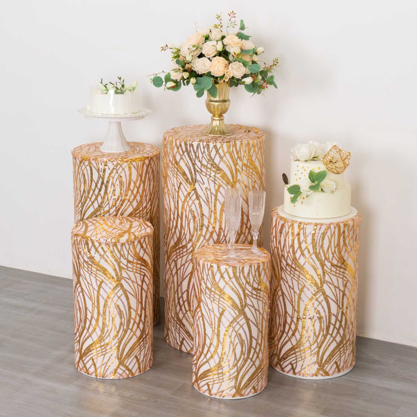 Set of 5 rose gold wave mesh cylinder pedestal stand covers with sequins.