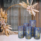 Set of 5 royal blue wave cylinder pedestal stand covers with sequins.