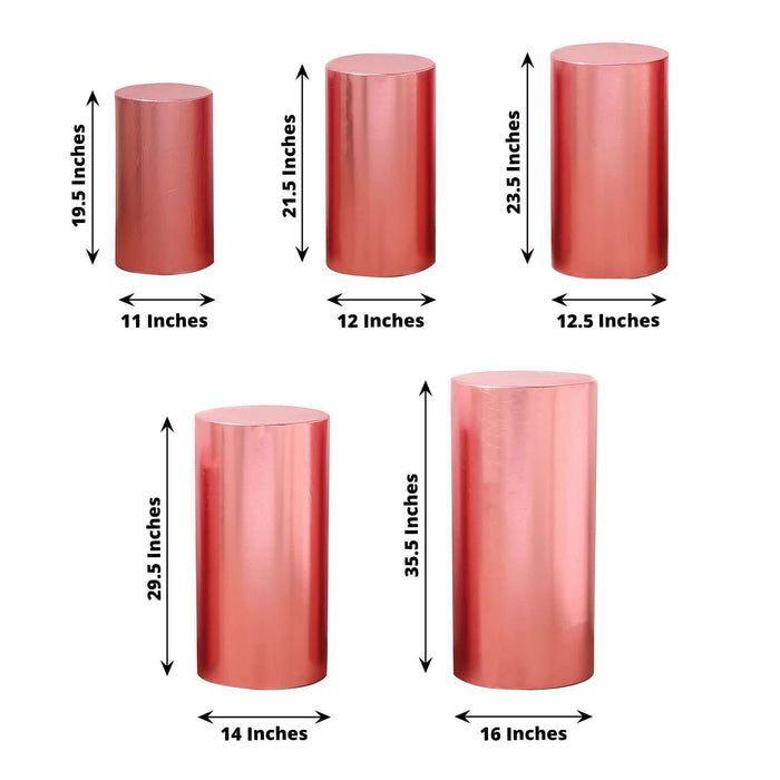 Set of 5 shiny rose gold spandex pedestal stand covers, various heights.