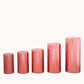 Set of 5 shiny rose gold pedestal stand covers in various heights.