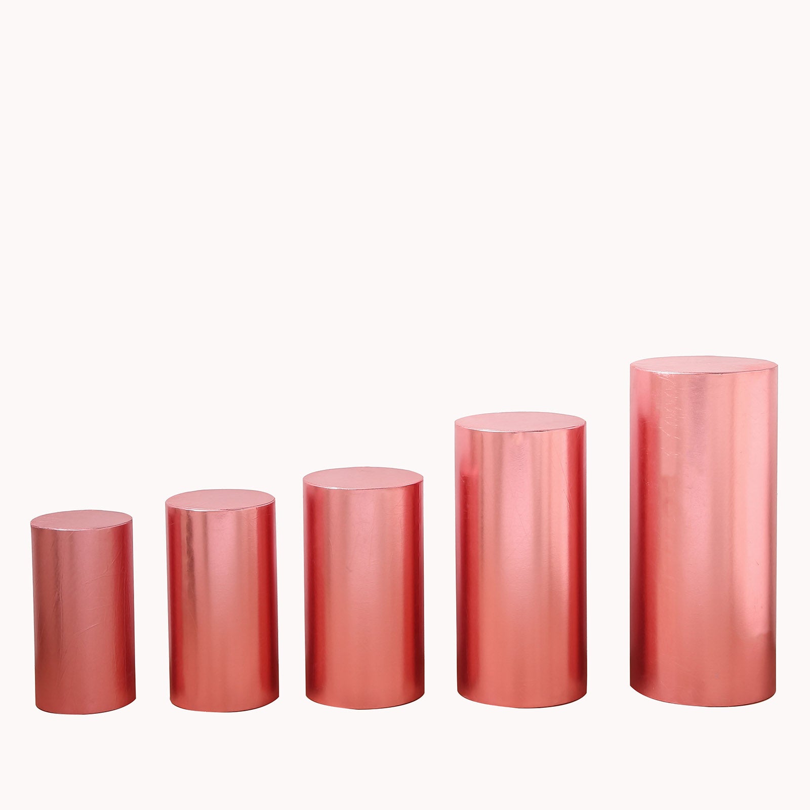 Set of 5 shiny rose gold pedestal stand covers in various heights.