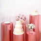Metallic rose gold pedestal stand covers with floral decorations and tableware.