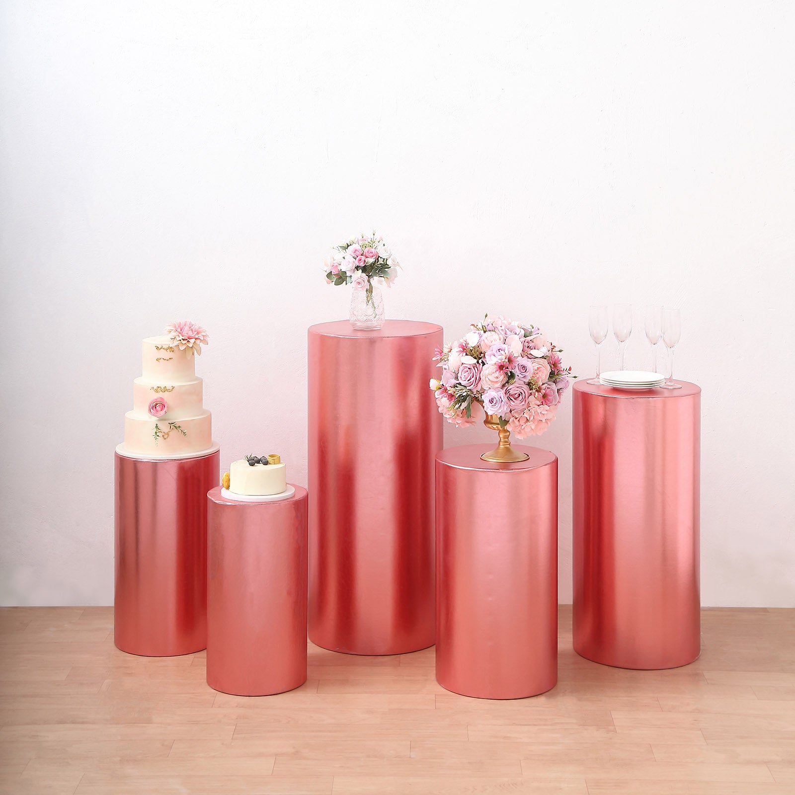 Metallic rose gold pedestal stand covers for events and displays.