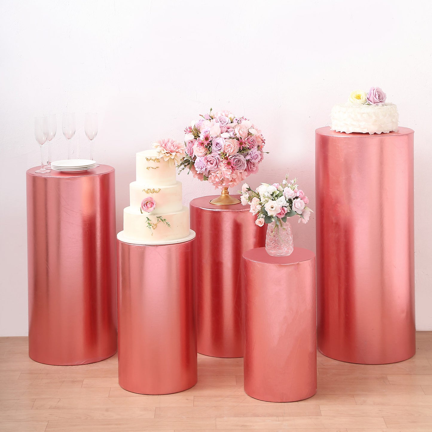 Metallic rose gold pedestal stand covers for events and displays.
