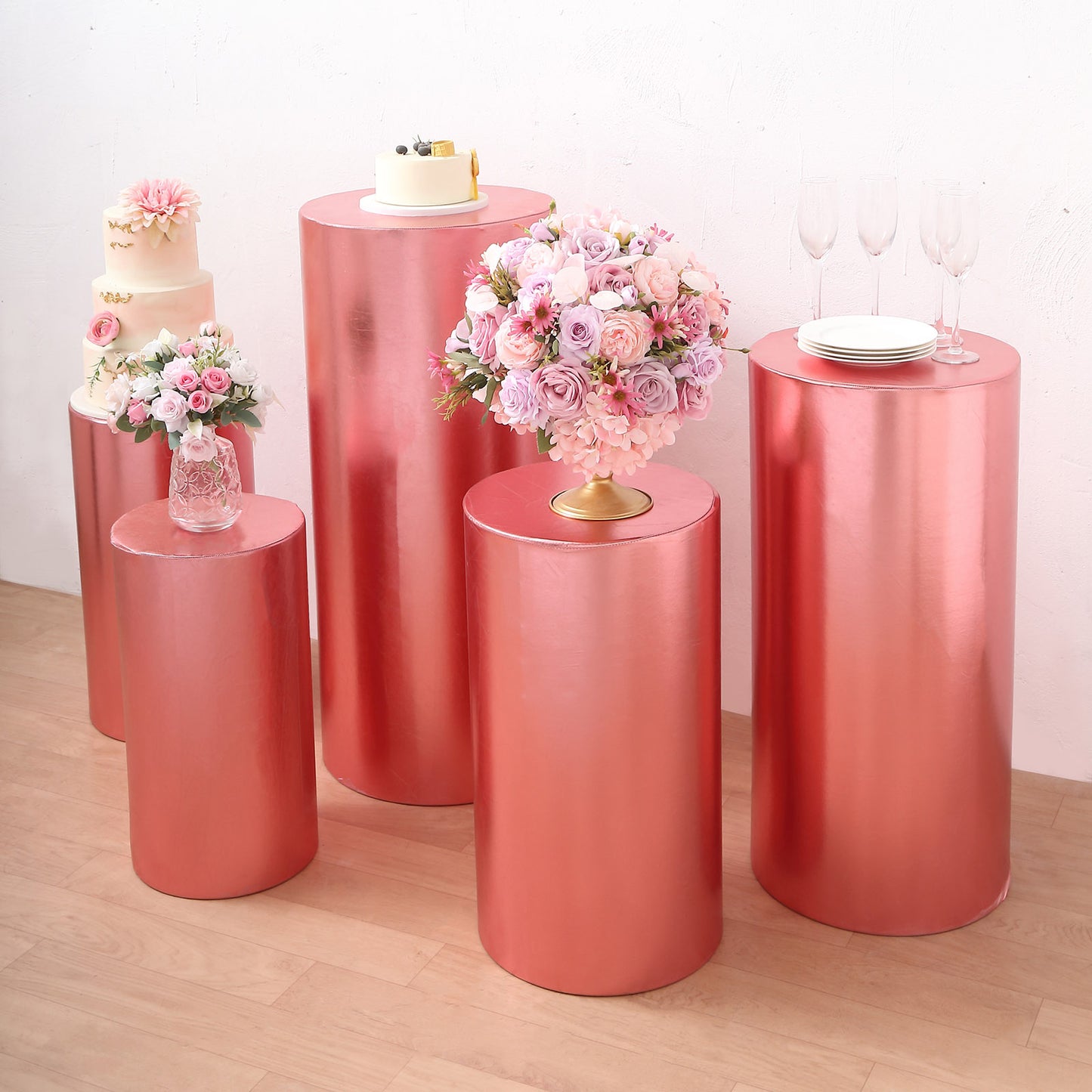 Metallic rose gold spandex pedestal stand covers on display.