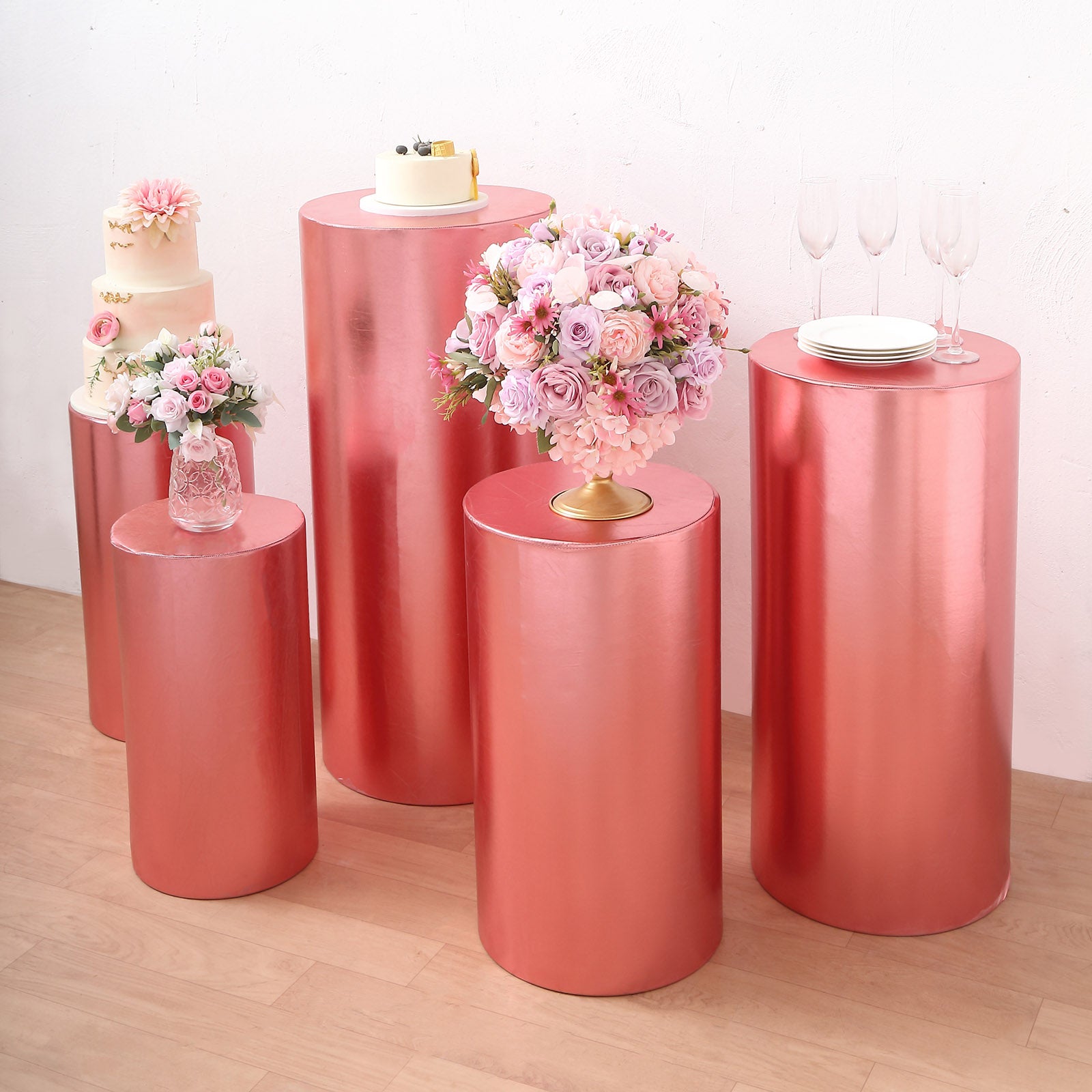 Metallic rose gold spandex pedestal stand covers on display.