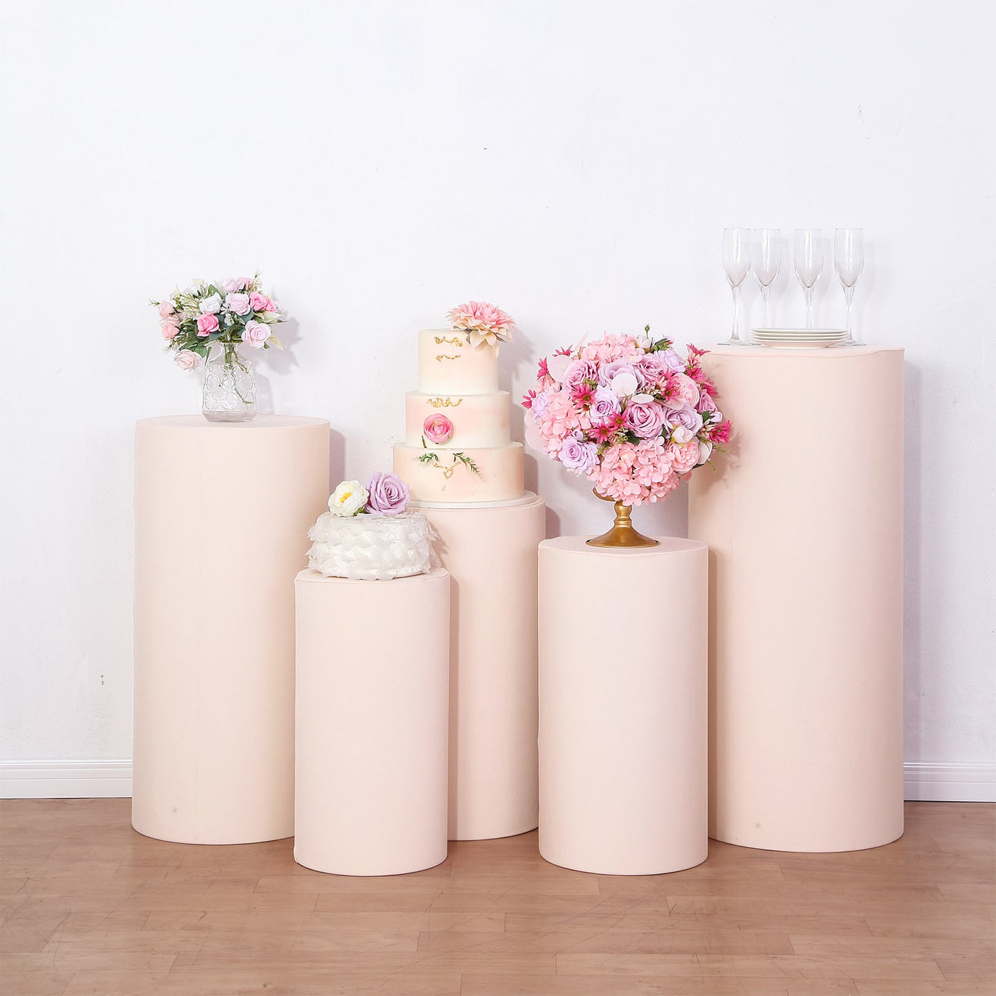 Blush spandex pedestal stand covers for display and decoration.