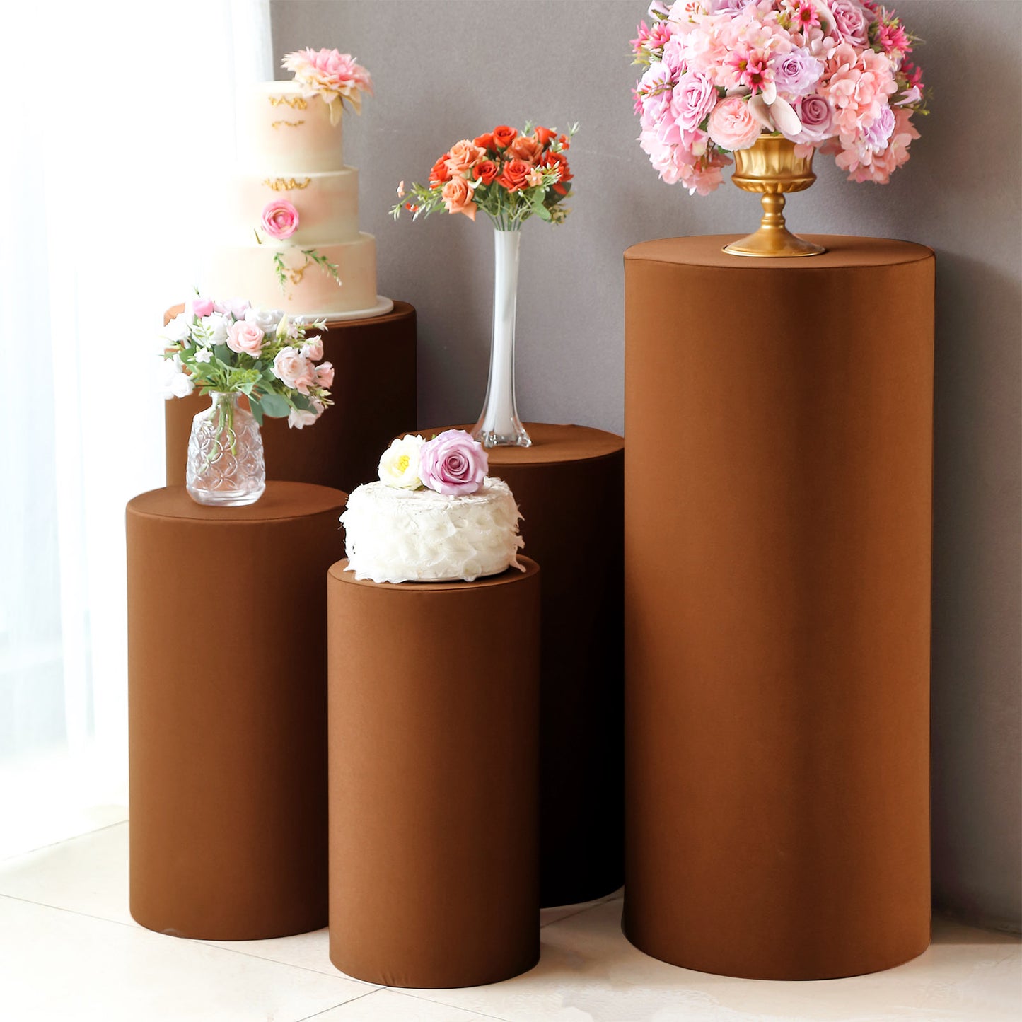 Cinnamon brown spandex pedestal stand covers for events and displays.