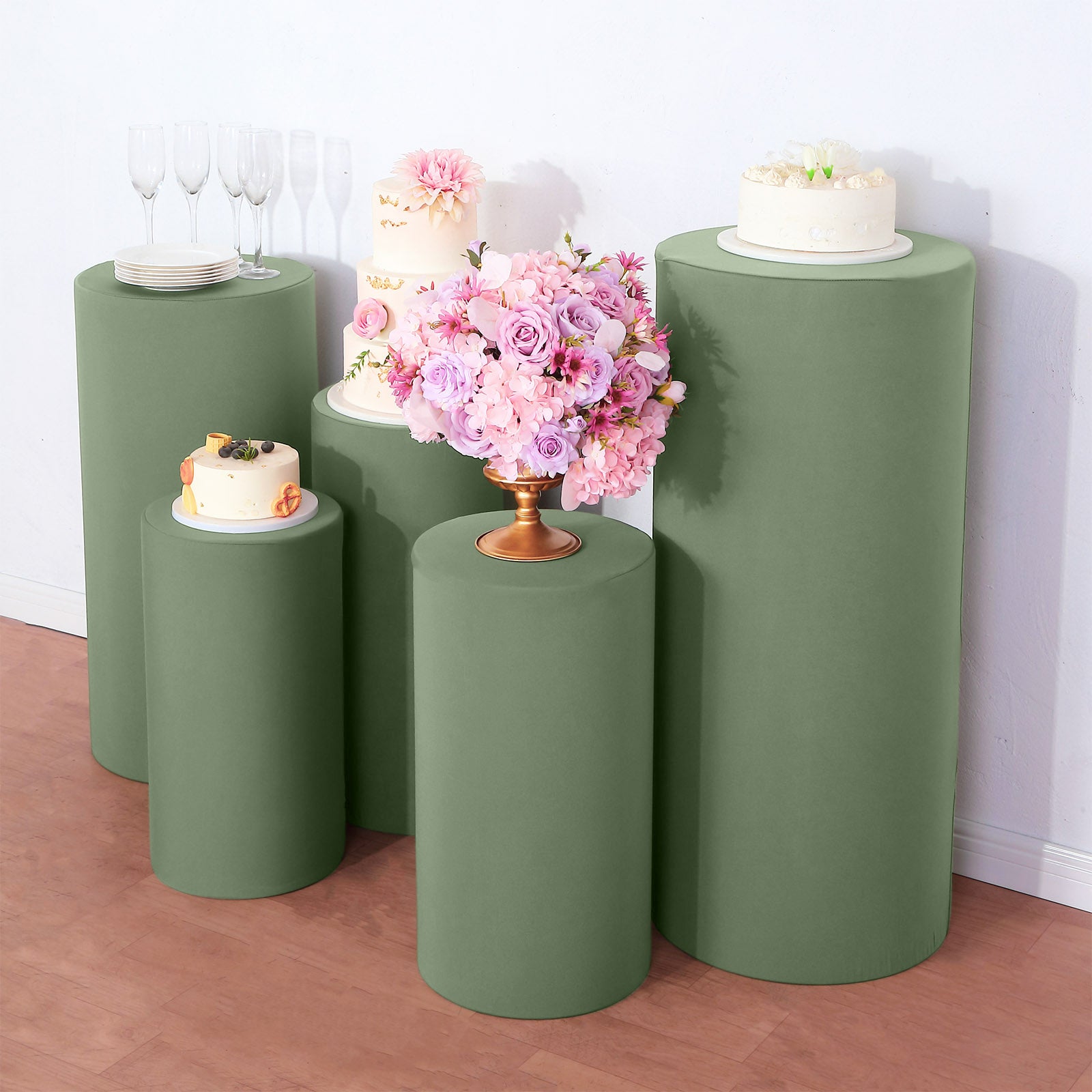 Dusty sage green spandex pedestal stand covers for events and displays.