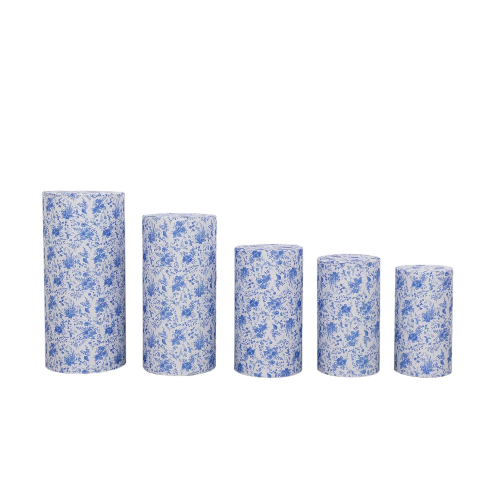 White and blue spandex pedestal stand covers in French toile floral pattern.