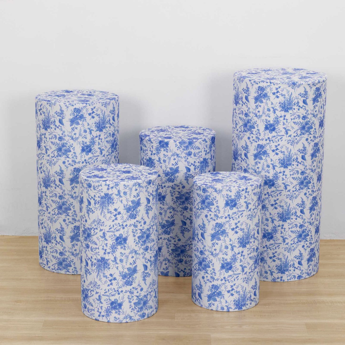 Set of 5 stretchable blue floral pedestal stand covers.